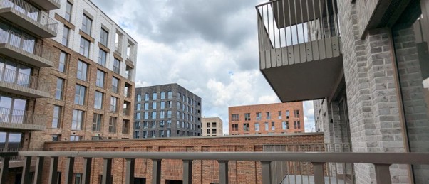 Multi-storey residential development with punched hole windows installed by building facade contractors.